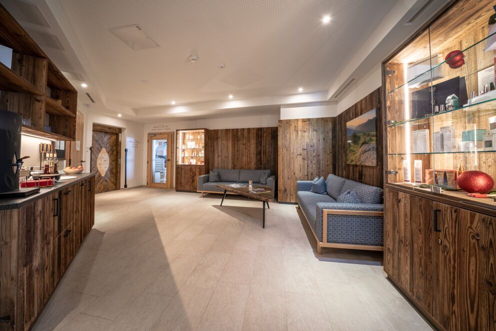 Stylishly furnished wellness area with comfortable seating and warm wooden accents.