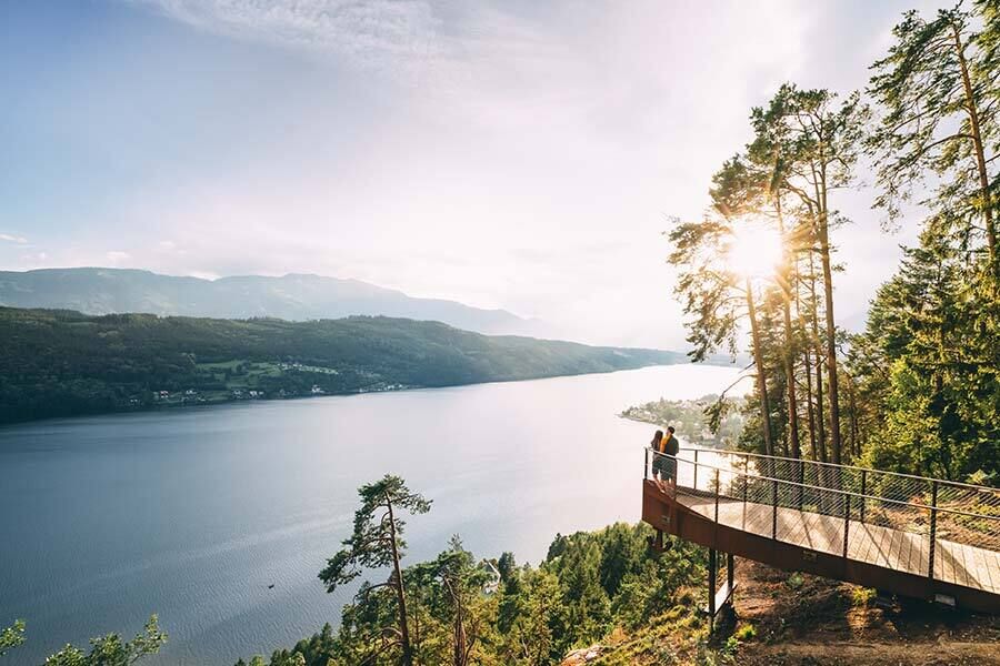La coppia gode di una vista tranquilla sul lago, circondata da una campagna pittoresca e da alberi.