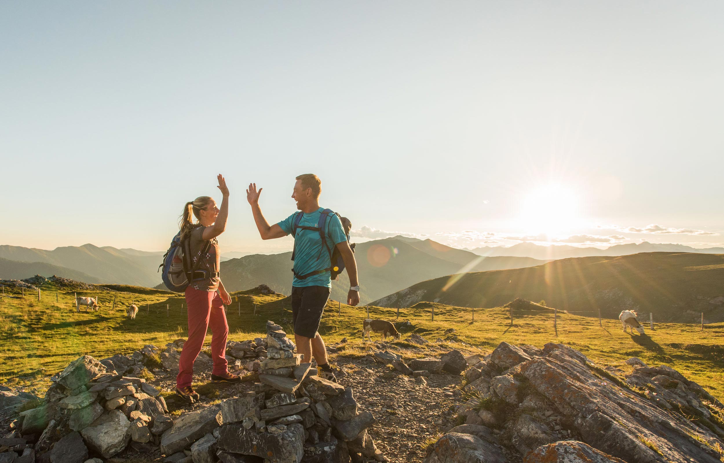 A couple goes hiking in the Nockberge mountains and give themselves a high-5